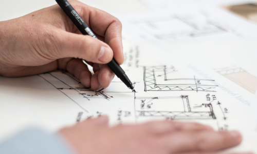 Man writing blueprints